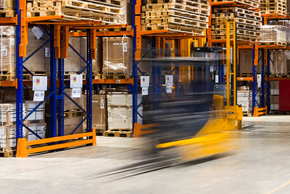 Moving forklift in warehouse